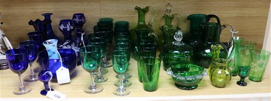Two glass eye baths, a collection of other green and blue glassware, some enamelled and a small Caithness vase